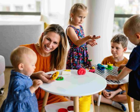 Children experiencing a Calm Transition at childcare with a teacher through play activities