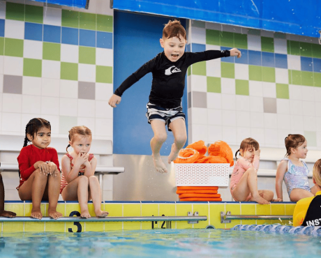 Swimming lessons for kids with an instructor at the pool