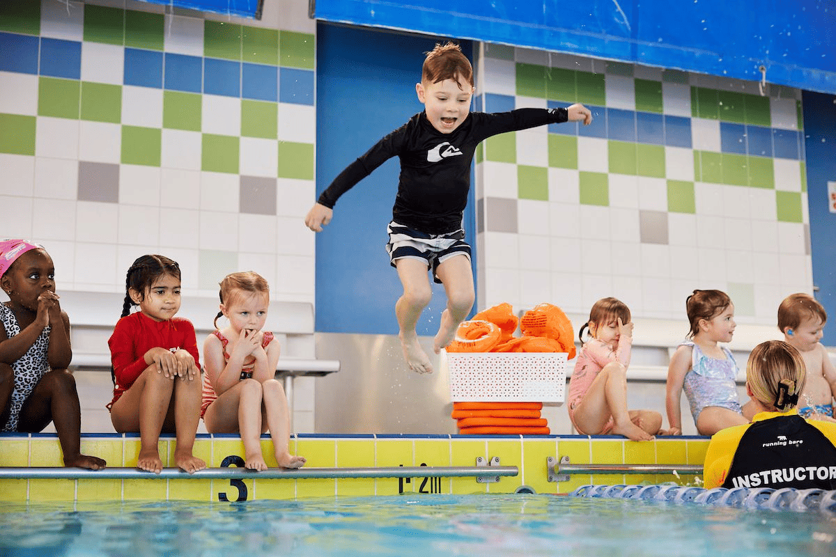 Swimming lessons for kids with an instructor at the pool
